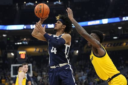 Jan 10, 2024; Milwaukee, Wisconsin, USA;  Butler Bulldogs guard DJ Davis (4) shoots in front of Marquette Golden Eagles guard Kam Jones (1) during the first half at Fiserv Forum. Mandatory Credit: Jeff Hanisch-USA TODAY Sports