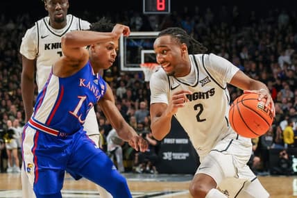 Jan 10, 2024; Orlando, Florida, USA; UCF Knights guard Shemarri Allen (2) drives to the basket around Kansas Jayhawks guard Elmarko Jackson (13) during the second half at Addition Financial Arena. Mandatory Credit: Mike Watters-USA TODAY Sports