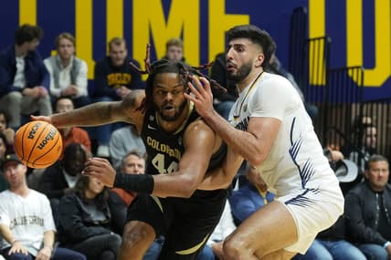Jan 10, 2024; Berkeley, California, USA; Colorado Buffaloes center Eddie Lampkin Jr. (left) dribbles against California Golden Bears forward Fardaws Aimaq (right) during the first half at Haas Pavilion. Mandatory Credit: Darren Yamashita-USA TODAY Sports