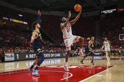Jan 11, 2024; College Park, Maryland, USA;  Maryland Terrapins forward Donta Scott (24) shoots a sky hook over Michigan Wolverines forward Olivier Nkamhoua (13) during the second half at Xfinity Center. Mandatory Credit: Tommy Gilligan-USA TODAY Sports