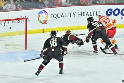 Jan 11, 2024; Tempe, Arizona, USA; Calgary Flames center Yegor Sharangovich (17) scores a short handed goal on Arizona Coyotes goaltender Karel Vejmelka (70) as left wing Jason Zucker (16) and defenseman J.J. Moser (90) defend in the first period at Mullett Arena. Mandatory Credit: Matt Kartozian-USA TODAY Sports