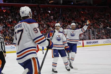 Jan 11, 2024; Detroit, Michigan, USA;  Edmonton Oilers center Connor McDavid (97) receives congratulations from teammates after scoring in the third period against the Detroit Red Wings at Little Caesars Arena. Mandatory Credit: Rick Osentoski-USA TODAY Sports