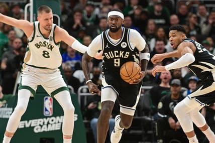 Jan 11, 2024; Milwaukee, Wisconsin, USA;  Milwaukee Bucks forward Bobby Portis (9) brings the ball down court against Boston Celtics center Kristaps Porzingis (8) in the second quarterat Fiserv Forum. Mandatory Credit: Benny Sieu-USA TODAY Sports