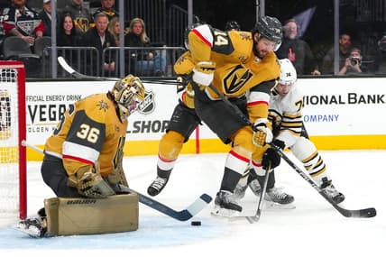 Jan 11, 2024; Las Vegas, Nevada, USA; Vegas Golden Knights goaltender Logan Thompson (36) makes a save as Vegas Golden Knights defenseman Nicolas Hague (14) fends off Boston Bruins left wing Jake DeBrusk (74) during the first period at T-Mobile Arena. Mandatory Credit: Stephen R. Sylvanie-USA TODAY Sports