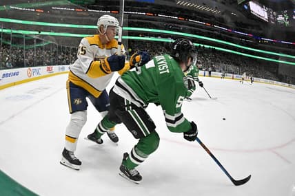 Jan 12, 2024; Dallas, Texas, USA; Nashville Predators center Juuso Parssinen (75) checks Dallas Stars defenseman Nils Lundkvist (5) during the first period at the American Airlines Center. Mandatory Credit: Jerome Miron-USA TODAY Sports
