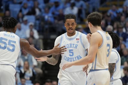 Jan 13, 2024; Chapel Hill, North Carolina, USA; North Carolina Tar Heels forward Armando Bacot (5) reacts with forward Harrison Ingram (55) and guard Cormac Ryan (3) in the first half at Dean E. Smith Center. Mandatory Credit: Bob Donnan-USA TODAY Sports