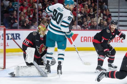 Jan 13, 2024; Ottawa, Ontario, CAN; San Jose Sharks right wing Justin Bailey (90) screens Ottawa Senators goalie Joonas Korpisalo (70) in the second period at the Canadian Tire Centre. Mandatory Credit: Marc DesRosiers-USA TODAY Sports