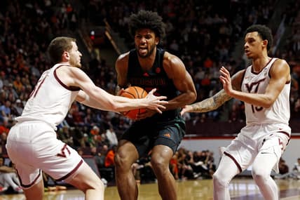 Jan 13, 2024; Blacksburg, Virginia, USA; Miami Hurricanes forward Norchad Omier (15) drives to the basket against Virginia Tech Hokies forward Robbie Beran (31) and center Lynn Kidd (15) during the first half at Cassell Coliseum. Mandatory Credit: Peter Casey-USA TODAY Sports