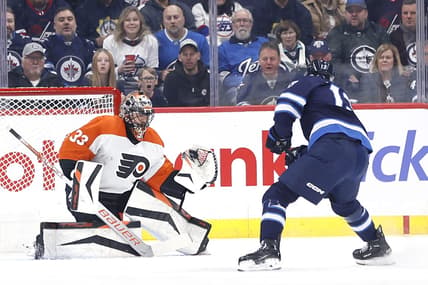 Jan 13, 2024; Winnipeg, Manitoba, CAN; Philadelphia Flyers goaltender Samuel Ersson (33) makes a glove save off a Winnipeg Jets center Gabriel Vilardi (13) shot in the first period at Canada Life Centre. Mandatory Credit: James Carey Lauder-USA TODAY Sports