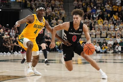 Jan 13, 2024; Waco, Texas, USA; Cincinnati Bearcats guard Dan Skillings Jr. (0) works around Baylor Bears guard Ja'Kobe Walter (4) during the first half at Paul and Alejandra Foster Pavilion. Mandatory Credit: Raymond Carlin III-USA TODAY Sports