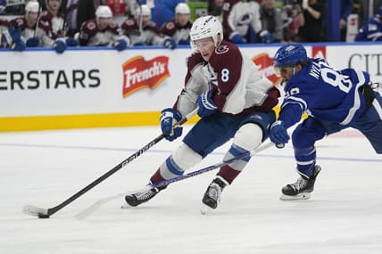 Jan 13, 2024; Toronto, Ontario, CAN; Colorado Avalanche defenseman Cale Makar (8) takes the puck away from Toronto Maple Leafs forward William Nylander (88) during the third period at Scotiabank Arena. Mandatory Credit: John E. Sokolowski-USA TODAY Sports