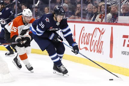Jan 13, 2024; Winnipeg, Manitoba, CAN; Winnipeg Jets center Morgan Barron (36) is chased down by Philadelphia Flyers defenseman Sean Walker (26) in the second period at Canada Life Centre. Mandatory Credit: James Carey Lauder-USA TODAY Sports