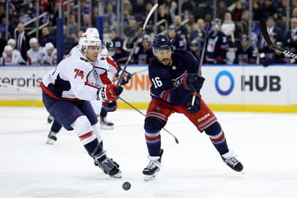 Jan 14, 2024; New York, New York, USA; New York Rangers center Vincent Trocheck (16) and Washington Capitals defenseman John Carlson (74) fight for the puck during the second period at Madison Square Garden. Mandatory Credit: Brad Penner-USA TODAY Sports