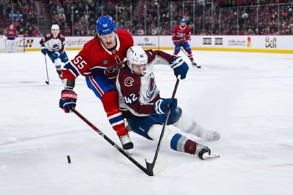 Jan 15, 2024; Montreal, Quebec, CAN; Colorado Avalanche defenseman Josh Manson (42) defends the puck against Montreal Canadiens left wing Michael Pezzetta (55) during the first period at Bell Centre. Mandatory Credit: David Kirouac-USA TODAY Sports