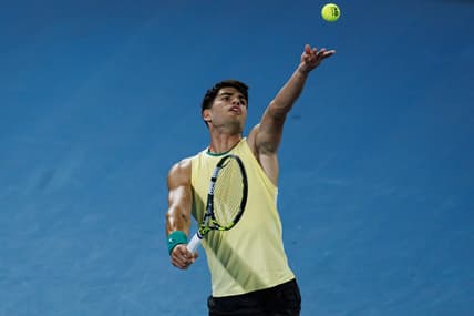 Jan 16, 2024; Melbourne, Victoria, Australia;   Carlos Alcaraz of Spain hits a shot against Richard Gasquet of France in the first round of the men s singles at the Australian Open. Mandatory Credit: Mike Frey-USA TODAY Sports