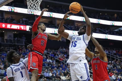 Jan 16, 2024; Newark, New Jersey, USA; Seton Hall Pirates center Jaden Bediako (15) rebounds against St. John's Red Storm center Joel Soriano (11) and guard Daniss Jenkins (5) in front of guard Kadary Richmond (1) during the first half at Prudential Center. Mandatory Credit: Vincent Carchietta-USA TODAY Sports