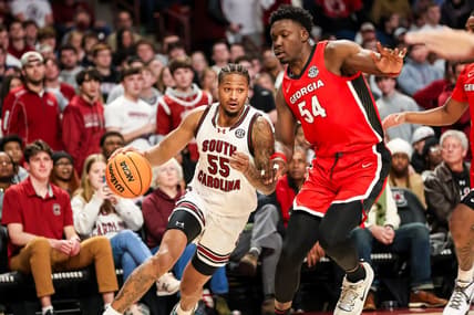 Jan 16, 2024; Columbia, South Carolina, USA; South Carolina Gamecocks guard Ta'Lon Cooper (55) drives around Georgia Bulldogs center Russel Tchewa (54) in the first half at Colonial Life Arena. Mandatory Credit: Jeff Blake-USA TODAY Sports