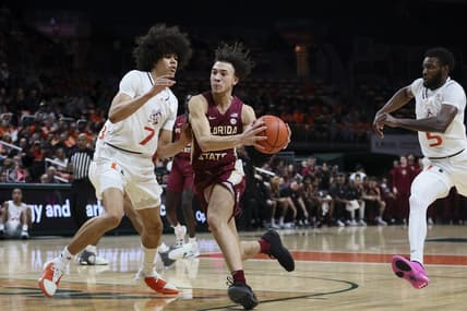 Jan 17, 2024; Coral Gables, Florida, USA; Florida State Seminoles guard Jalen Warley (1) drives to the basket against Miami Hurricanes guard Kyshawn George (7) during the first half at Watsco Center. Mandatory Credit: Sam Navarro-USA TODAY Sports