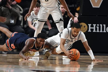Jan 17, 2024; Nashville, Tennessee, USA; Auburn Tigers guard K.D. Johnson (0) and Vanderbilt Commodores guard Isaiah West (4) dive for a loose ball during the first half at Memorial Gymnasium. Mandatory Credit: Christopher Hanewinckel-USA TODAY Sports