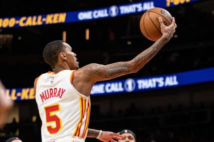 Jan 17, 2024; Atlanta, Georgia, USA; Atlanta Hawks guard Dejounte Murray (5) lays in the ball against Orlando Magic during fourth quarter at State Farm Arena. Mandatory Credit: Jordan Godfree-USA TODAY Sports