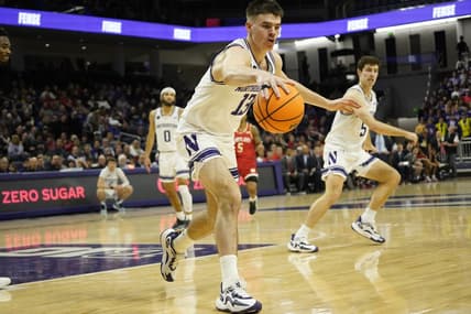 Jan 17, 2024; Evanston, Illinois, USA; Northwestern Wildcats guard Brooks Barnhizer (13) grabs a loose ball against the Maryland Terrapins during the first half at Welsh-Ryan Arena. Mandatory Credit: David Banks-USA TODAY Sports