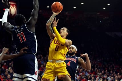 Jan 17, 2024; Tucson, Arizona, USA; USC Trojans guard Kobe Johnson (0) drives to the net against Arizona Wildcats center Oumar Ballo (11) during the first half at McKale Center. Mandatory Credit: Zachary BonDurant-USA TODAY Sports