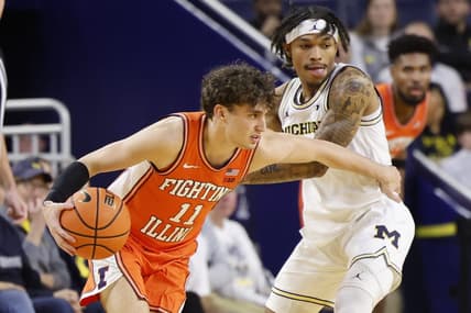 Jan 18, 2024; Ann Arbor, Michigan, USA;  Illinois Fighting Illini guard Niccolo Moretti (11) dribbles the ball while Michigan Wolverines guard Dug McDaniel (0) defends in the first half at Crisler Center. Mandatory Credit: Rick Osentoski-USA TODAY Sports
