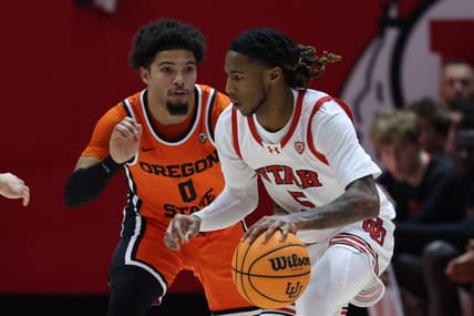 Jan 18, 2024; Salt Lake City, Utah, USA; Utah Utes guard Deivon Smith (5) drives against Oregon State Beavers guard Jordan Pope (0) during the first half at Jon M. Huntsman Center. Mandatory Credit: Rob Gray-USA TODAY Sports