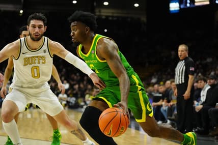 Jan 18, 2024; Boulder, Colorado, USA; Oregon Ducks guard Jermaine Couisnard (5) drives at Colorado Buffaloes guard Luke O'Brien (0) in the first half at the CU Events Center. Mandatory Credit: Ron Chenoy-USA TODAY Sports
