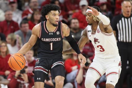 Jan 20, 2024; Fayetteville, Arkansas, USA; South Carolina Gamecocks guard Jacobi Wright (1) drives against Arkansas Razorbacks guard El Ellis (3) during the first half at Bud Walton Arena. Mandatory Credit: Nelson Chenault-USA TODAY Sports