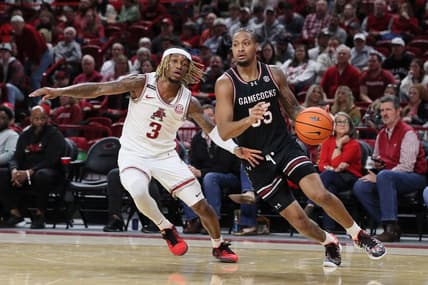 Jan 20, 2024; Fayetteville, Arkansas, USA; South Carolina Gamecocks guard Ta Lon Cooper (55) dribbles by Arkansas Razorbacks guard El Ellis (3) during the second half at Bud Walton Arena. Gamecocks won 77-64. Mandatory Credit: Nelson Chenault-USA TODAY Sports