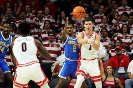 Jan 20, 2024; Tucson, Arizona, USA; Arizona Wildcats guard Pelle Larsson (3) makes a pass to guard Jaden Bradley (0) against UCLA Bruins guard Dylan Andrews (2) during the first half at McKale Center. Mandatory Credit: Zachary BonDurant-USA TODAY Sports