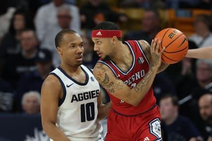 Jan 20, 2024; Logan, Utah, USA; Fresno State Bulldogs guard Isaiah Hill (3) looks to move the ball against Utah State Aggies guard Darius Brown II (10) during the first half at Dee Glen Smith Spectrum. Mandatory Credit: Rob Gray-USA TODAY Sports