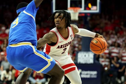 Jan 20, 2024; Tucson, Arizona, USA; Arizona Wildcats guard Caleb Love (2) dribbles the ball agaisnt UCLA Bruins forward Adem Bona (3) during the second half at McKale Center. Mandatory Credit: Zachary BonDurant-USA TODAY Sports