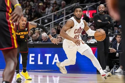 Jan 20, 2024; Atlanta, Georgia, USA; Cleveland Cavaliers guard Donovan Mitchell (45) dribbles past Atlanta Hawks guard Dejounte Murray (5) during the first half at State Farm Arena. Mandatory Credit: Dale Zanine-USA TODAY Sports