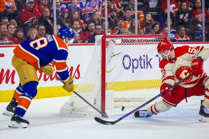 Jan 20, 2024; Calgary, Alberta, CAN; Edmonton Oilers left wing Zach Hyman (18) scores a goal as Calgary Flames defenseman MacKenzie Weegar (52) defends during the third period at Scotiabank Saddledome. Mandatory Credit: Sergei Belski-USA TODAY Sports