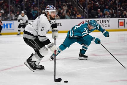 Jan 22, 2024; Los Angeles, California, USA; Los Angeles Kings defenseman Drew Doughty (8) moves the puck against San Jose Sharks left wing William Eklund (72) during the third period at Crypto.com Arena. Mandatory Credit: Gary A. Vasquez-USA TODAY Sports
