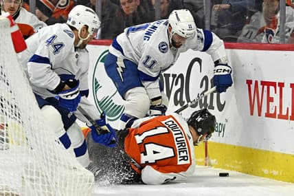 Jan 23, 2024; Philadelphia, Pennsylvania, USA; Philadelphia Flyers center Sean Couturier (14) battles for the puck with Tampa Bay Lightning center Luke Glendening (11) and defenseman Calvin de Haan (44) battle for the puck during the first period at Wells Fargo Center. Mandatory Credit: Eric Hartline-USA TODAY Sports