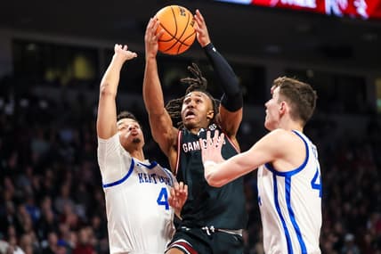 Jan 23, 2024; Columbia, South Carolina, USA; South Carolina Gamecocks guard Meechie Johnson (5) drives between Kentucky Wildcats forward Tre Mitchell (4) and forward Zvonimir Ivisic (44) in the first half at Colonial Life Arena. Mandatory Credit: Jeff Blake-USA TODAY Sports
