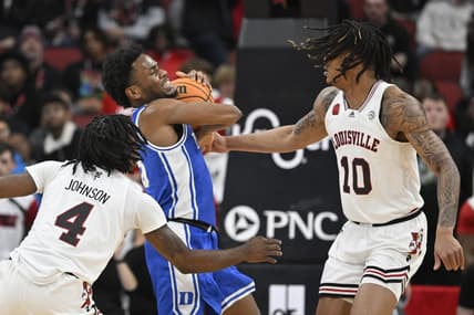 Jan 23, 2024; Louisville, Kentucky, USA;  Duke Blue Devils guard Jeremy Roach (3) battles Louisville Cardinals forward Kaleb Glenn (10) and guard Ty-Laur Johnson (4) during the first half at KFC Yum! Center. Mandatory Credit: Jamie Rhodes-USA TODAY Sports