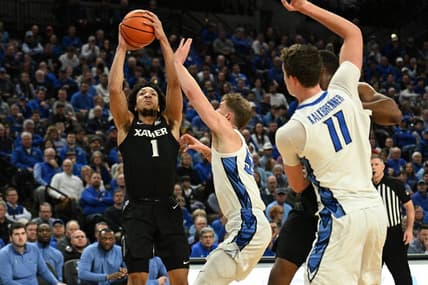 Jan 23, 2024; Omaha, Nebraska, USA;  Xavier Musketeers guard Desmond Claude (1) scores over Creighton Bluejays guard Baylor Scheierman (55) in the first half at CHI Health Center Omaha. Mandatory Credit: Steven Branscombe-USA TODAY Sports