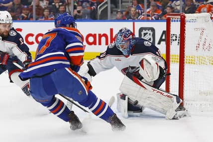 Jan 23, 2024; Edmonton, Alberta, CAN; Columbus Blue Jackets goaltender Elvis Merzlikins (90) makes a save on  on Edmonton Oilers forward Connor McDavid (97) during the first period at Rogers Place. Mandatory Credit: Perry Nelson-USA TODAY Sports