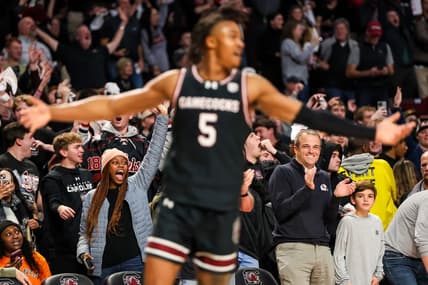 Jan 23, 2024; Columbia, South Carolina, USA; South Carolina Gamecocks head football coach Shane Beamer, bottom right, celebrates a three point basket by guard Meechie Johnson (5), foreground, against the Kentucky Wildcats in the second half at Colonial Life Arena. Mandatory Credit: Jeff Blake-USA TODAY Sports