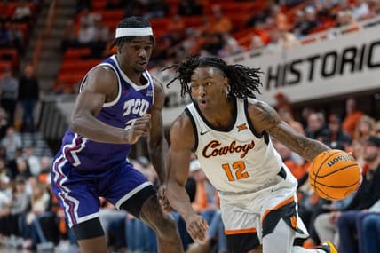 Jan 23, 2024; Stillwater, Oklahoma, USA; Oklahoma State Cowboys guard Javon Small (12) drives around TCU Horned Frogs forward Emanuel Miller (2) during the first half at Gallagher-Iba Arena. Mandatory Credit: William Purnell-USA TODAY Sports