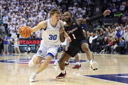 Jan 23, 2024; Provo, Utah, USA; Brigham Young Cougars guard Dallin Hall (30) drives the ball against Houston Cougars guard Jamal Shead (1) during the second half at Marriott Center. Mandatory Credit: Rob Gray-USA TODAY Sports