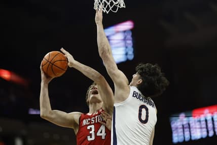 Jan 24, 2024; Charlottesville, Virginia, USA; North Carolina State Wolfpack forward Ben Middlebrooks (34) shoots the ball as Virginia Cavaliers forward Blake Buchanan (0) defends in the first half at John Paul Jones Arena. Mandatory Credit: Geoff Burke-USA TODAY Sports