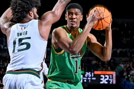 Jan 24, 2024; South Bend, Indiana, USA; Notre Dame Fighting Irish forward Kebba Njie (14) looks to shoot as Miami Hurricanes forward Norchad Omier (15) defends in the first half at the Purcell Pavilion. Mandatory Credit: Matt Cashore-USA TODAY Sports