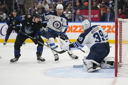 Jan 24, 2024; Toronto, Ontario, CAN; Winnipeg Jets goaltender Laurent Brossoit (39) makes a save as  Toronto Maple Leafs forward David Kampf (64) looks for a rebound during the first period at Scotiabank Arena. Mandatory Credit: John E. Sokolowski-USA TODAY Sports