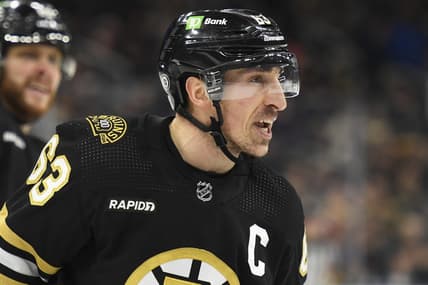 Jan 24, 2024; Boston, Massachusetts, USA;  Boston Bruins left wing Brad Marchand (63) has words for the refereee after being called for a penalty during the first period against the Carolina Hurricanes at TD Garden. Mandatory Credit: Bob DeChiara-USA TODAY Sports