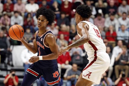 Jan 24, 2024; Tuscaloosa, Alabama, USA; Auburn Tigers guard Aden Holloway (1) dribbles around Alabama Crimson Tide guard Aaron Estrada (55) during the first half at Coleman Coliseum. Mandatory Credit: Butch Dill-USA TODAY Sports
